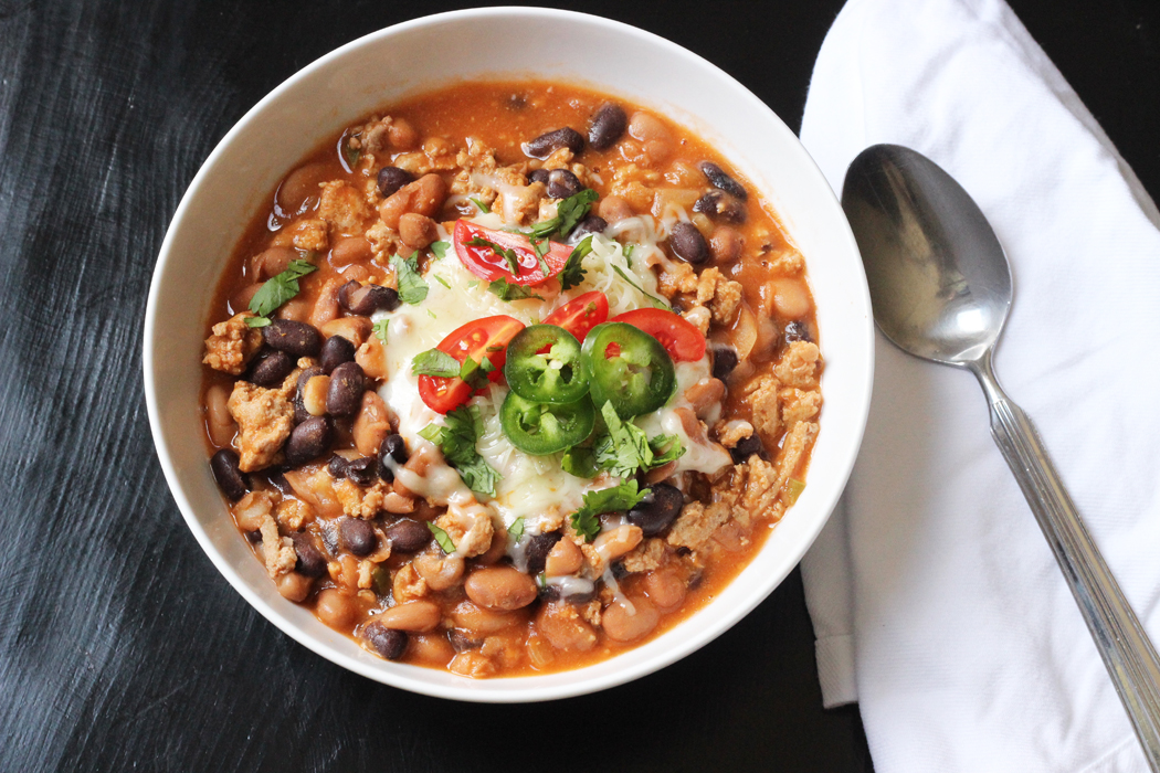 bowl of homemade chili with beans and lots of toppings