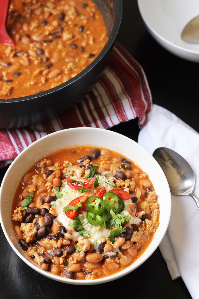 bowl of homemade chili with beans and meat and toppings