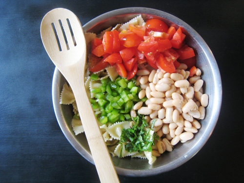 A bowl of pasta salad ingredients