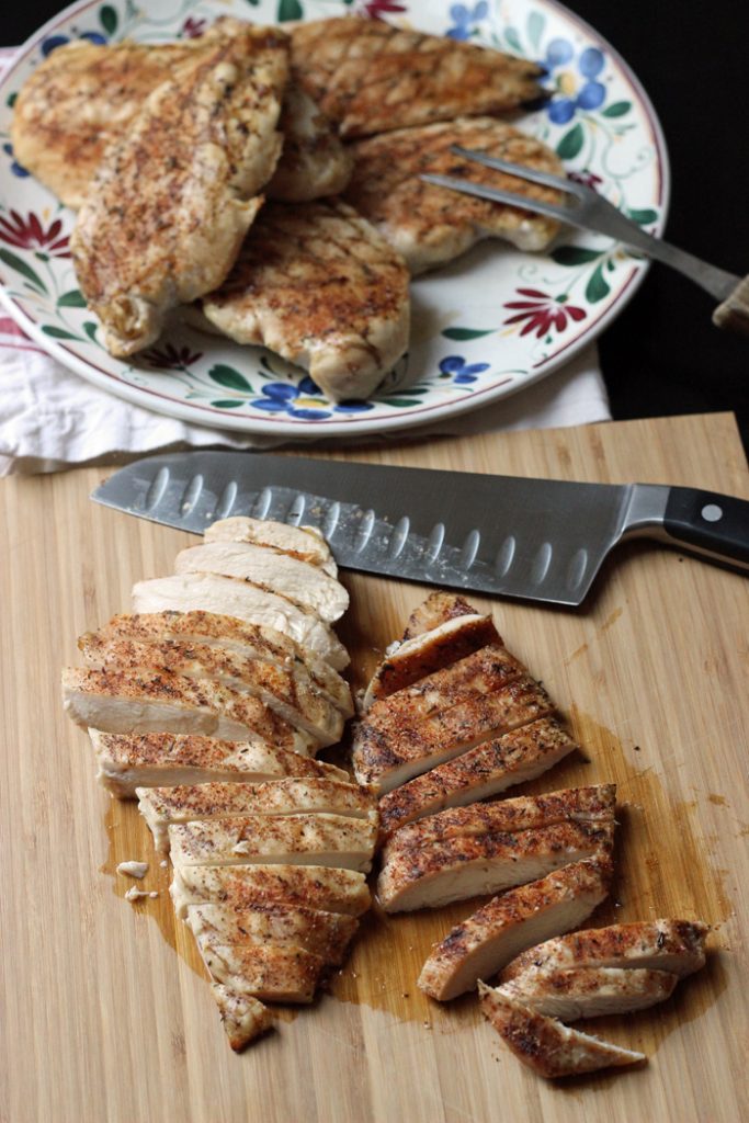 grilled chicken sliced on a cutting board