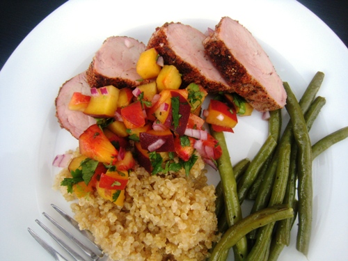 A plate of pork tenderloin and salsa