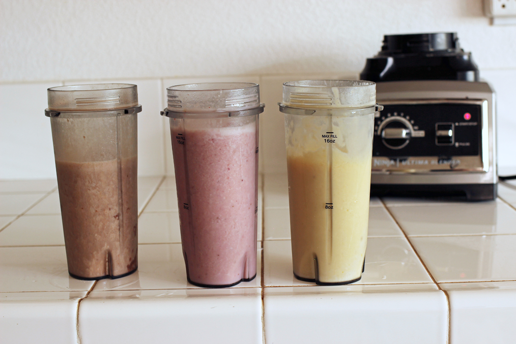 blender cups lined up on counter by high speed blender