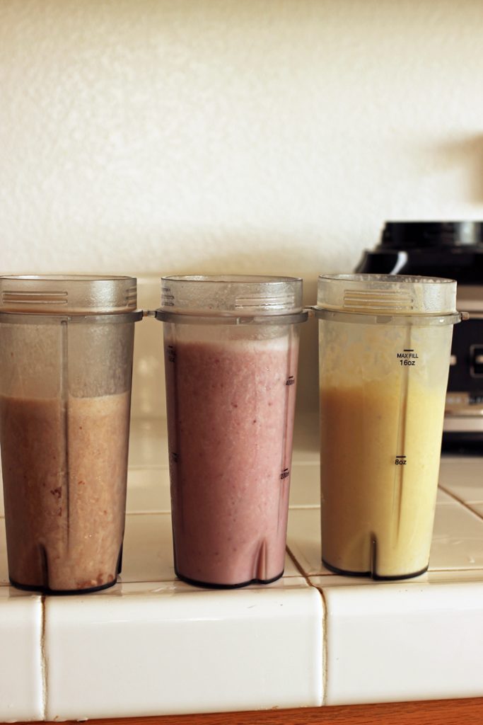 blender cups with different types of smoothie