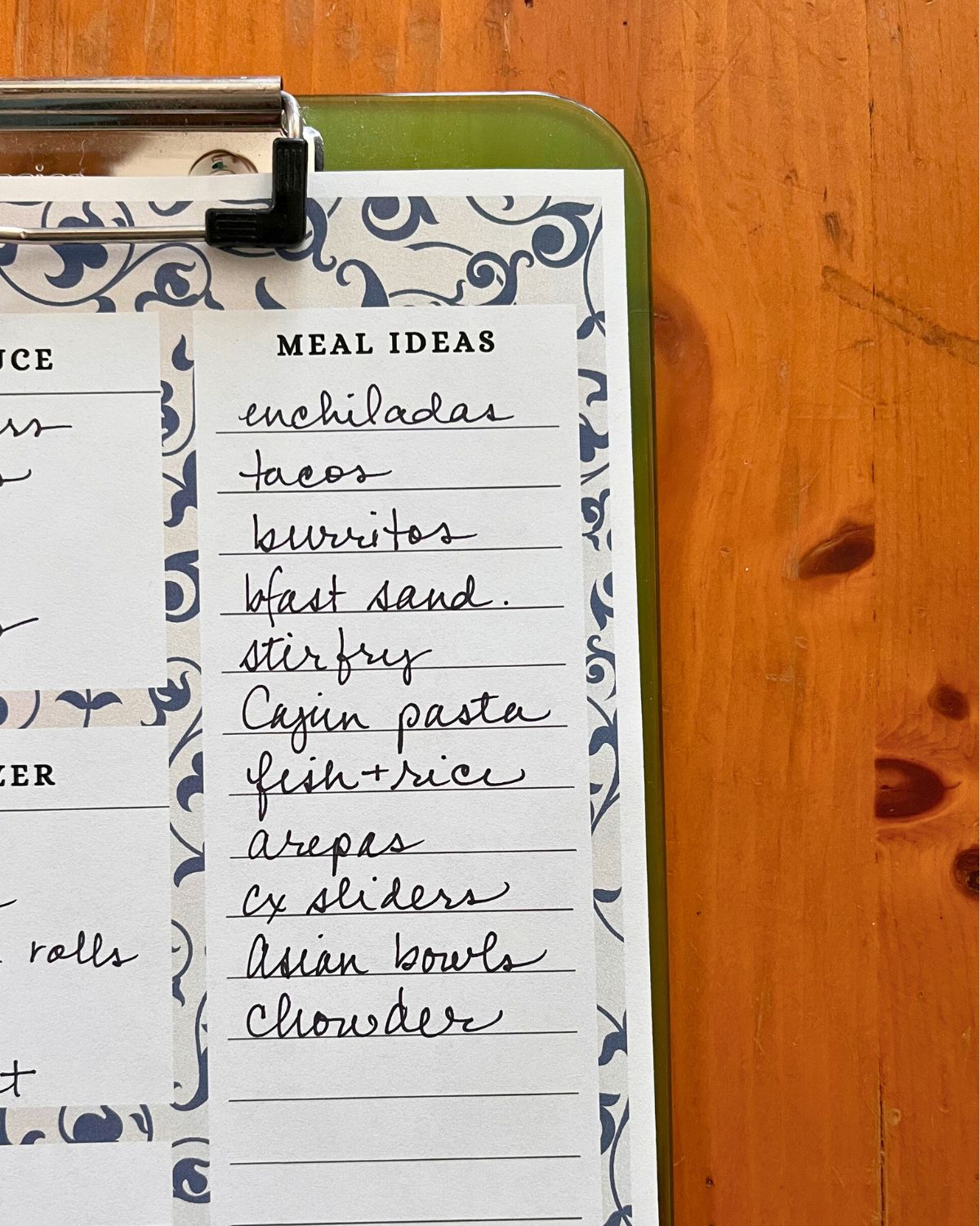 close-up of meal ideas listed on a green clipboard.