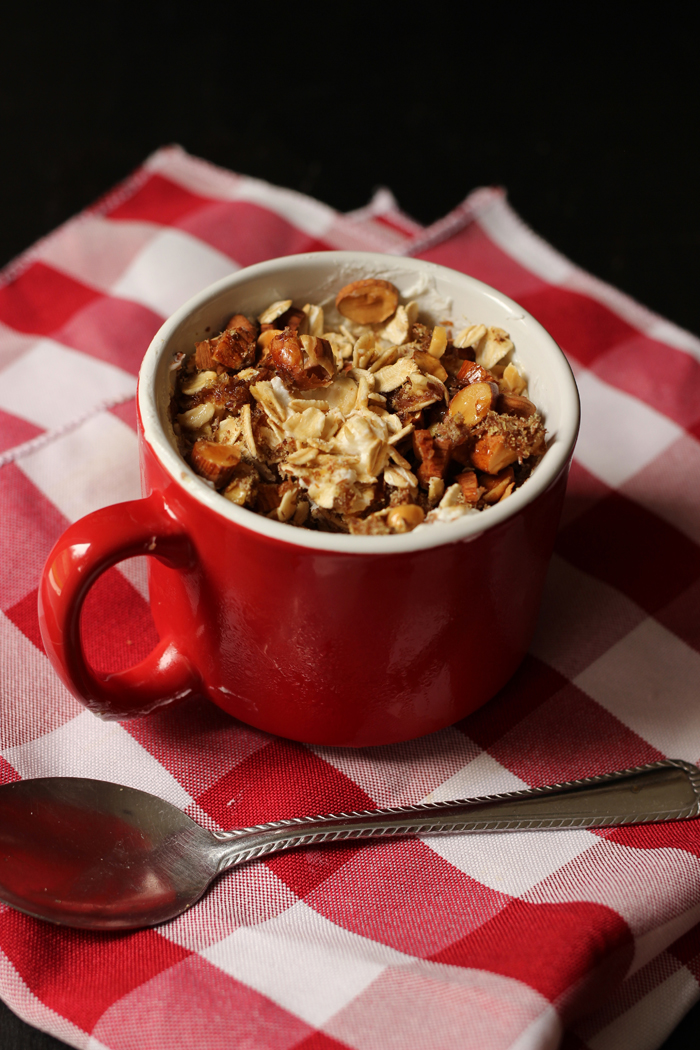 mug of yogurt nuts and oats with spoon