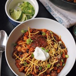 A bowl of chili on a table