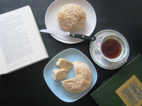 A plate of seed cakes and a cup of tea