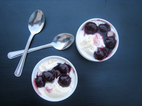 bowls of cherries jubilee with spoons