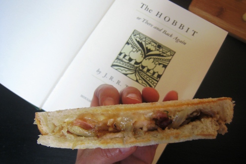 A half Bacon and Brie Panini and copy of the Hobbit book