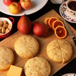 tables set with cakes cheese fruit nuts and tea