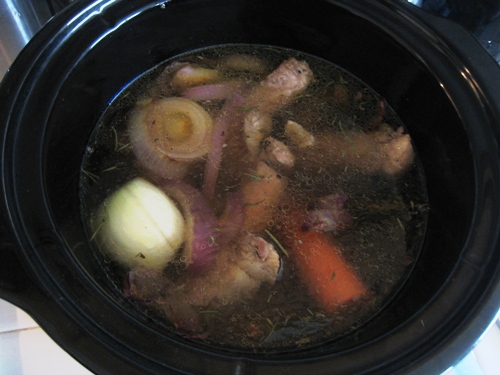 A close up of stock in slow cooker