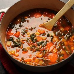 pot of minestrone with wooden spoon