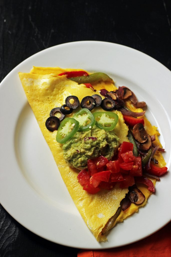 Fajita omelet on a plate on a table