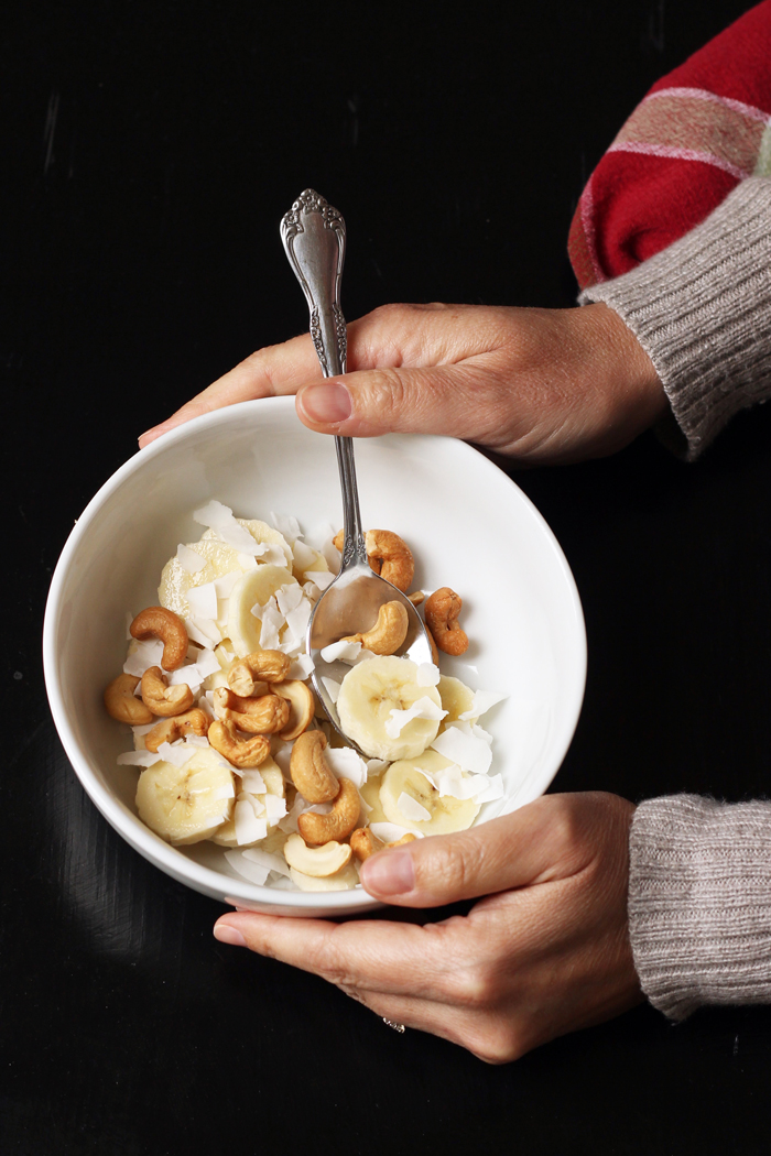 A person holding a bowl of monkey salad