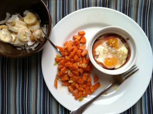 A plate of baked eggs and sweet potato on a table