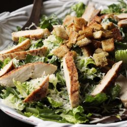 A plate of chicken caesar salad