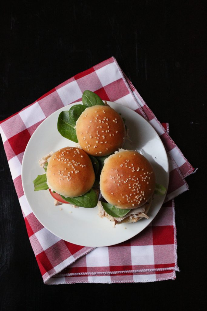 A plate of pulled chicken sliders