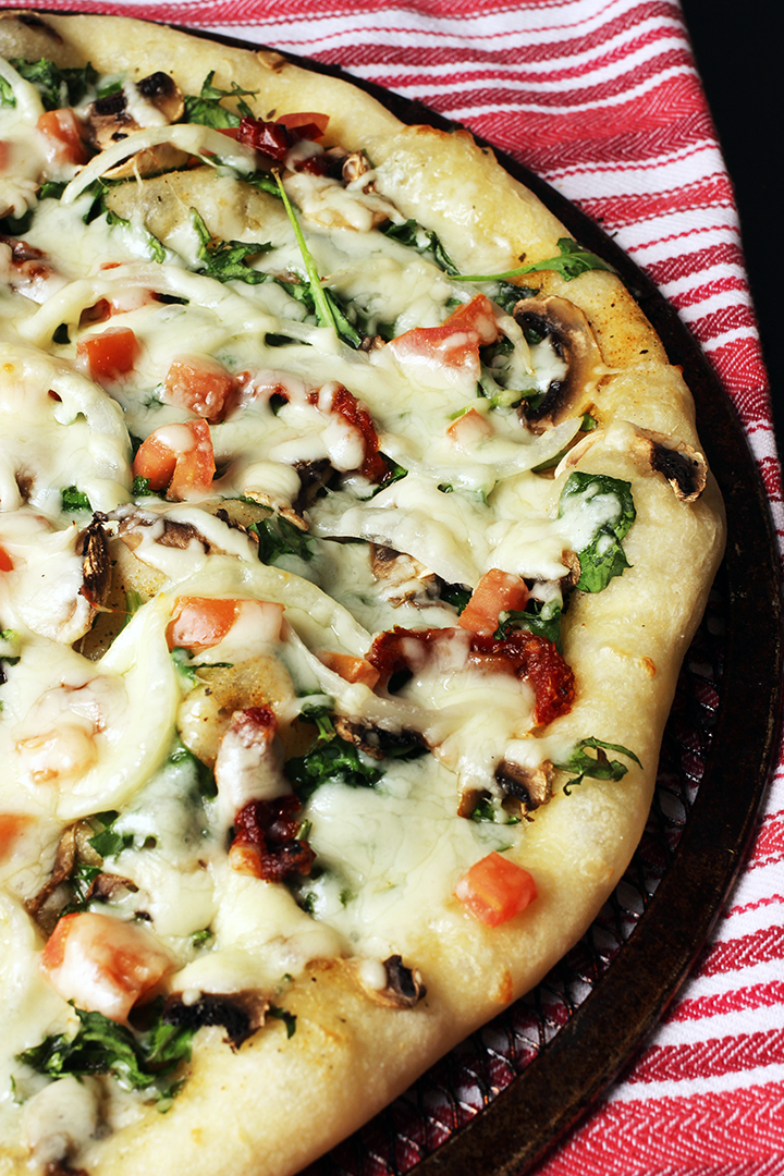 kale pizza on red cloth