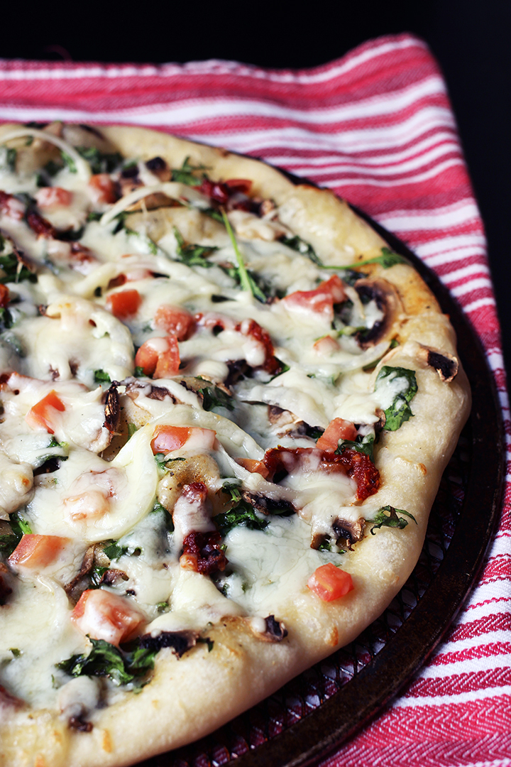 view of half pizza on pan on red cloth