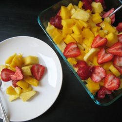 A bowl and plate of Fruit salad