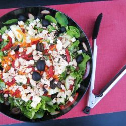 A bowl of salad, with Tomato and olives