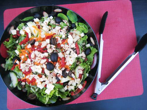 green salad with sundried tomatoes and pepper jack