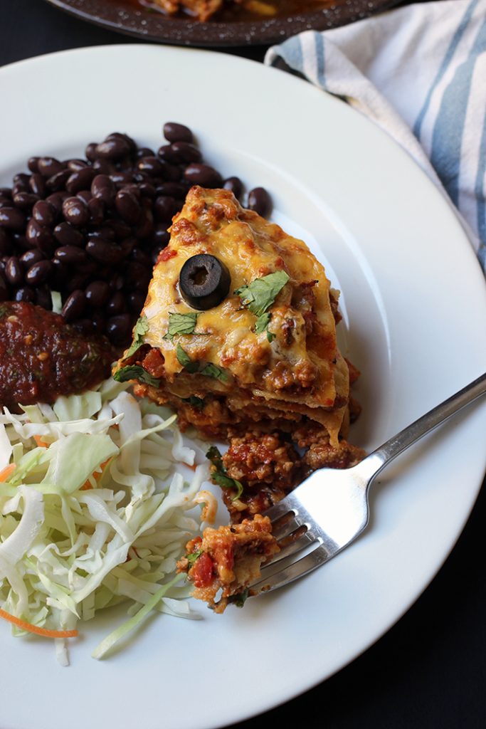 dinner plate with tortilla casserole beans and cabbage salad