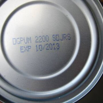 A close up of a can's expiration date
