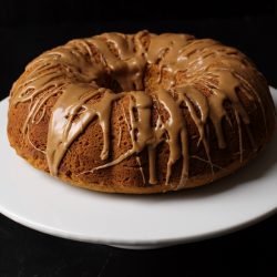 white cake stand with Pumpkin Cake with Maple Glaze