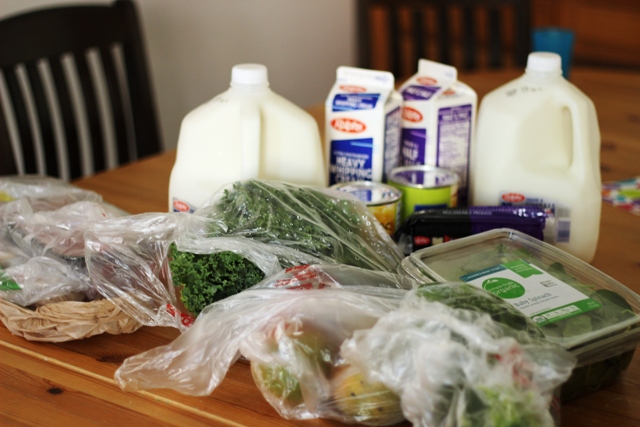 milk and other groceries on table