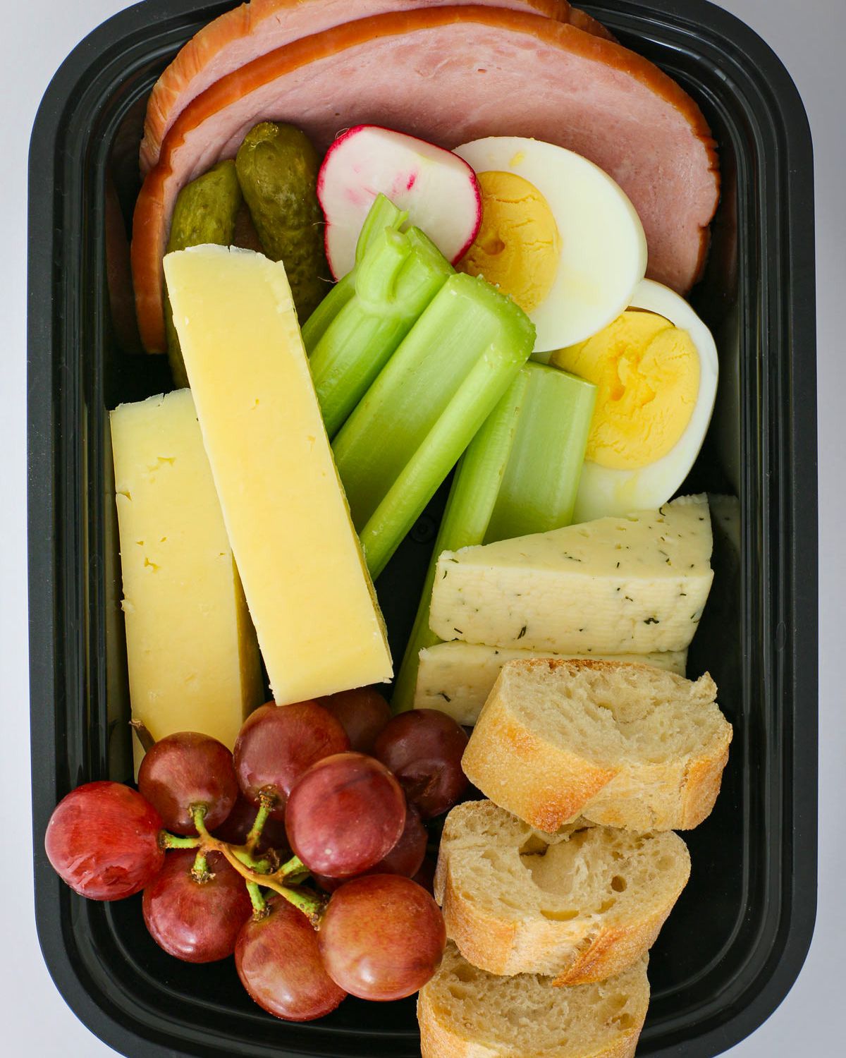 snacky lunch in a black meal prep box.