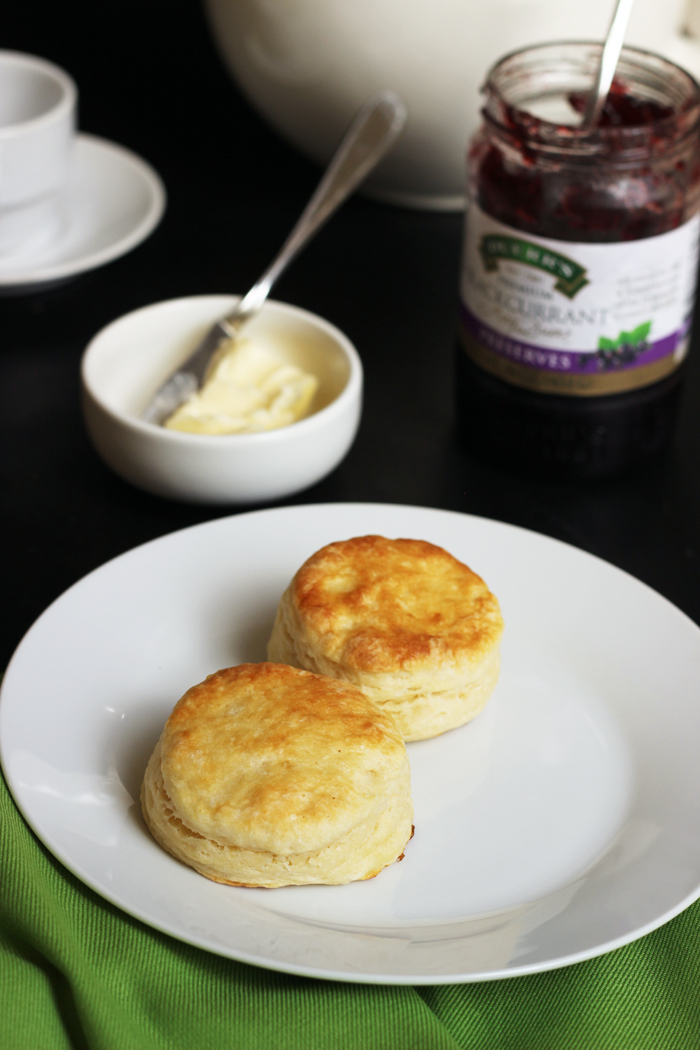 Flaky Buttermilk Biscuits on plate, with butter and jam