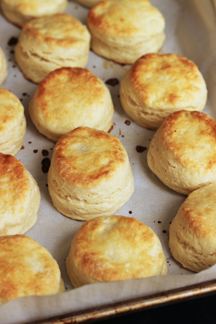 Flaky Buttermilk Biscuits cooling on parchment-lined tray