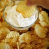 A close up of a chip in onion dip