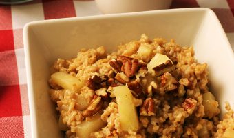 bowl of apple oatmeal with nuts and sugar
