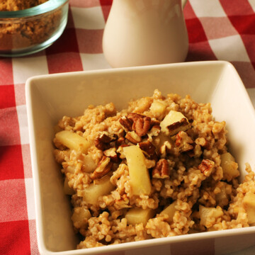 bowl of apple oatmeal with nuts and sugar