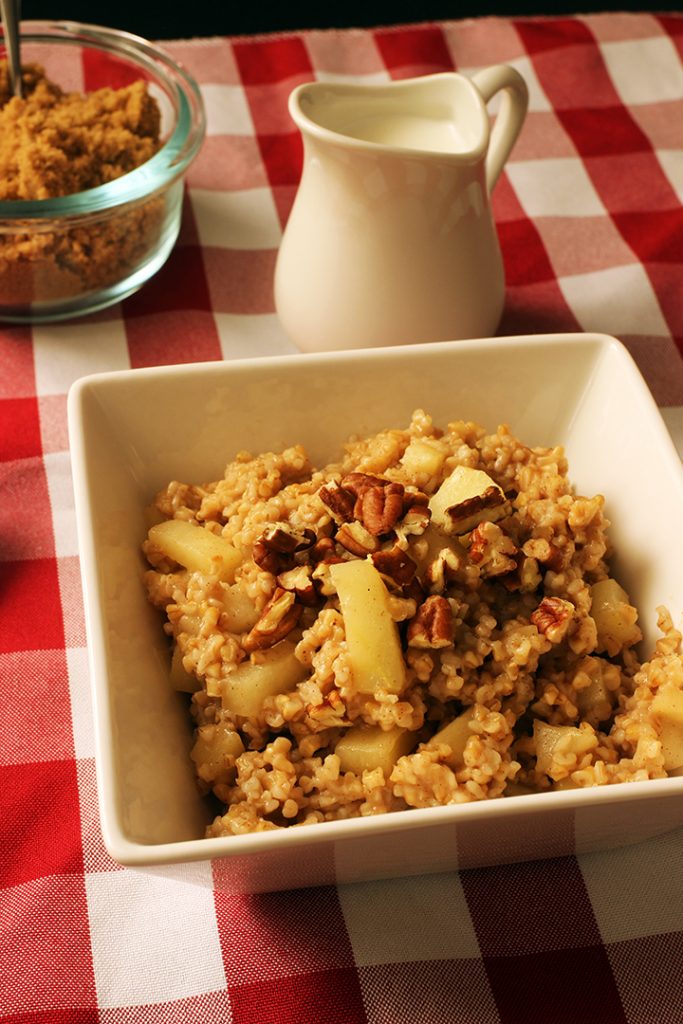 bowl of apple oatmeal with nuts and sugar