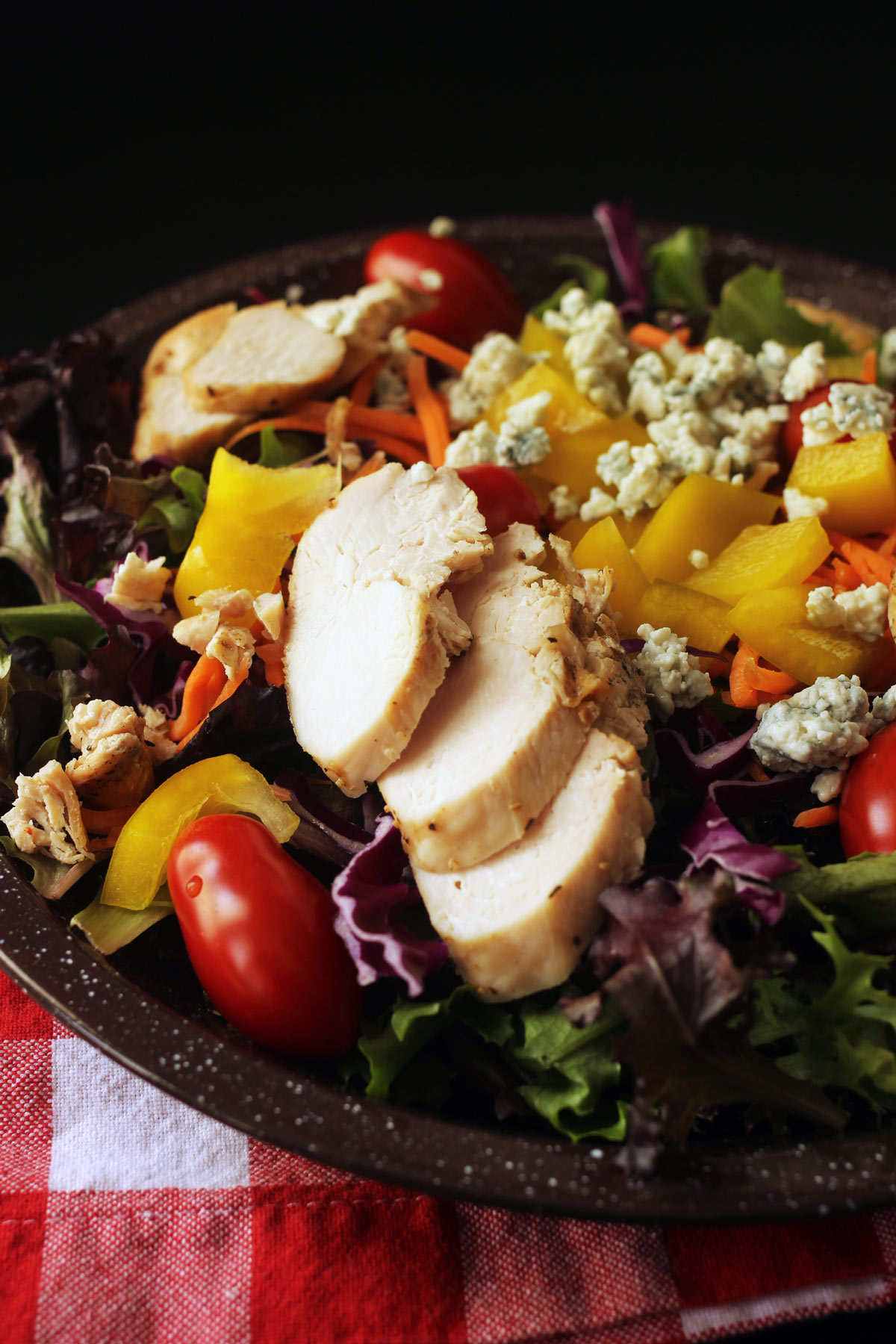 grilled chicken strips atop salad