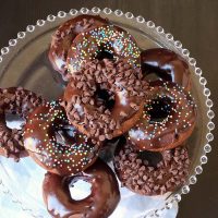 stack of chocolate donuts on glass beaded stand