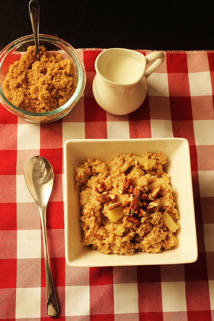 table set with bowl of brown sugar, pitcher of cream and bowl of oatmeal