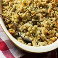 herbed stuffing in casserole dish with checked red cloth