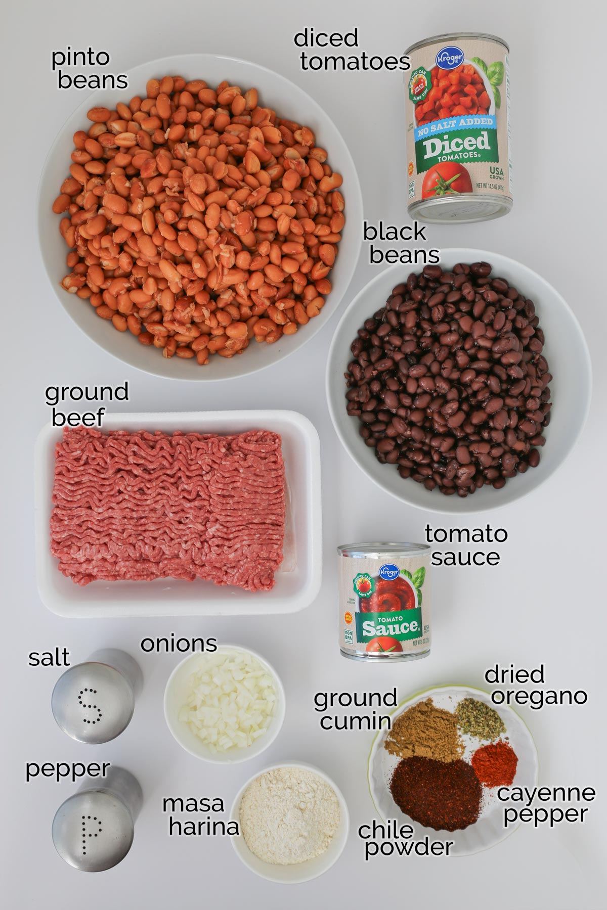 ingredients to make slow cooker chili laid out on a white counter.