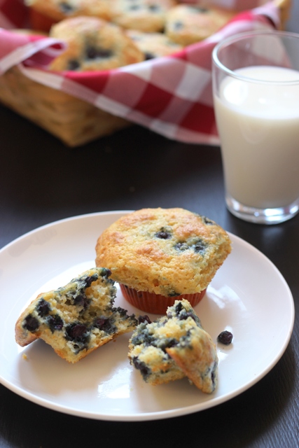 A close up of a plate of muffins and glass of milk