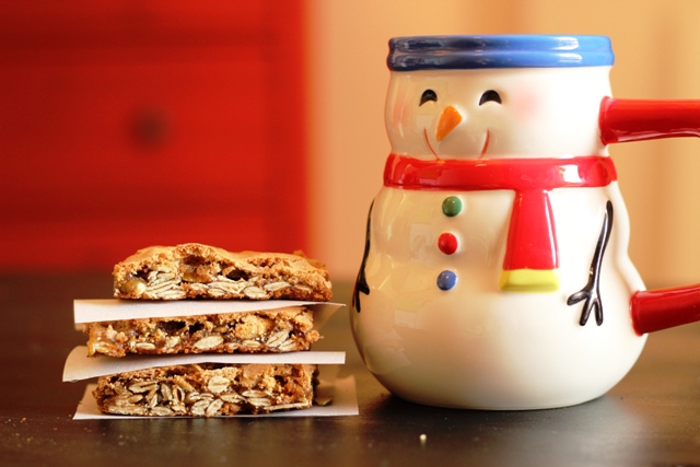 stack of cookie bars next to snowman mug