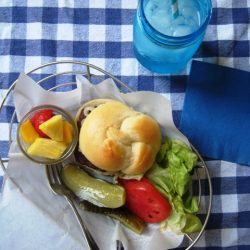 a basket of hamburger and toppings
