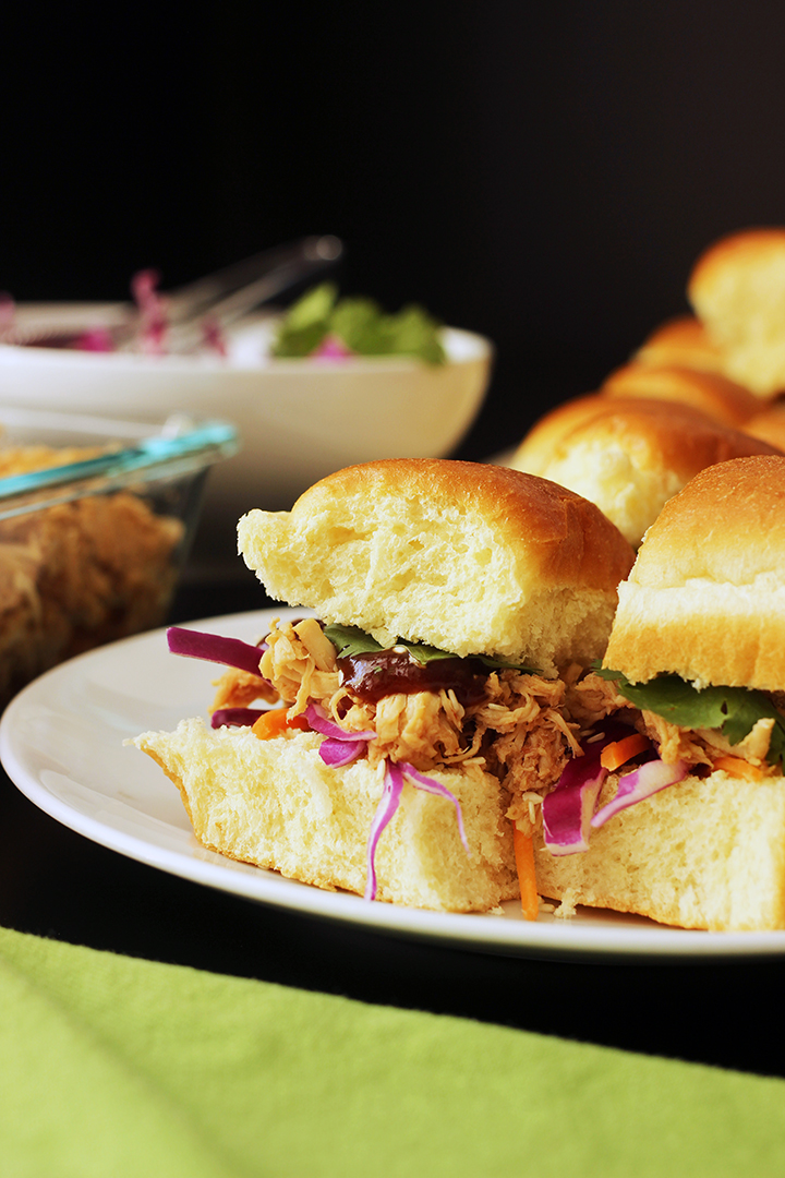 sweet and sour pulled chicken on hawaiian rolls on plate