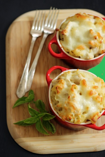 two ramekins of Alfredo Mac and Cheese on a cutting board with forks