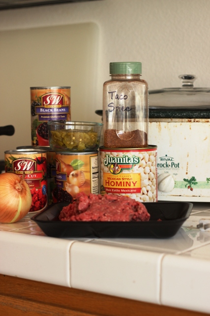 cans and ground beef on counter by crockpot