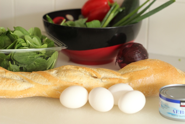 A close up of eggs and baguette on counter