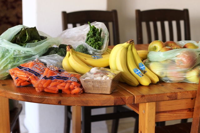 bananas and other groceries on a wooden table